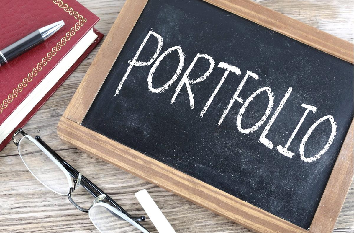 The word "portfolio" written in chalk on a small blackboard